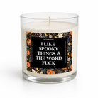 A clear glass jar candle with white wax and a single wick, featuring a Halloween-themed label with the text 'I LIKE SPOOKY THINGS & THE WORD FUCK' on a white background.