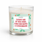 A clear glass jar candle with white wax and a humorous holiday label that reads 'LIGHT ME IF YOU FEEL LIKE DECKING A COWORKER' in red text, shown on a clean white background.