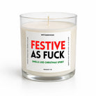 A clear glass jar candle with white wax and a printed white label reading 'FESTIVE AS FUCK' in red and black, with smaller green text below, photographed on a clean white background.