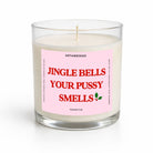 A single-wick soy candle in a clear glass jar with a pink label that reads 'JINGLE BELLS YOUR PUSSY SMELLS' in red text, on a white background.