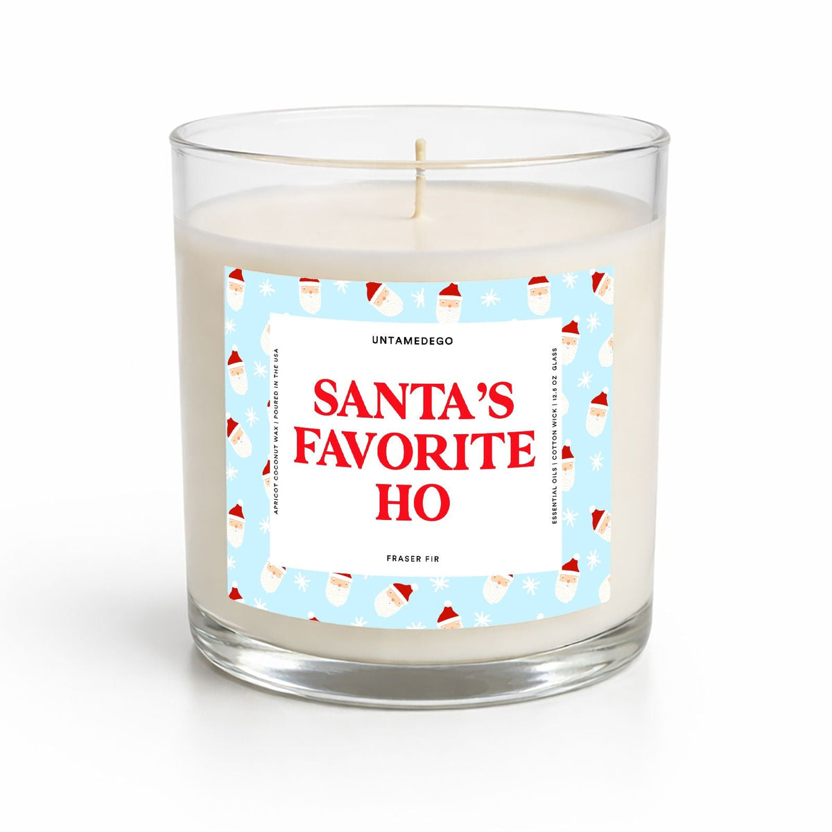 A clear glass jar candle with white wax and a festive label that reads 'SANTA'S FAVORITE HO' in red text on a light blue background with Santa illustrations. The brand name 'UNTRAMEDGO' is visible at the top of the label.