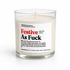 A 12 oz coconut apricot candle in a clear glass jar with a white label that reads 'Festive As Fuck' by Fraser Fir. The candle is lit, showing a soft warm glow, and is photographed on a clean white background.