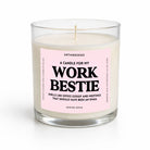A clear glass jar candle with white wax and a light pink label that reads 'A CANDLE FOR MY WORK BESTIE' in bold black text. The brand name 'UNTAMEDEGO' is visible at the top of the label, and 'WINTER APPLE' appears at the bottom.