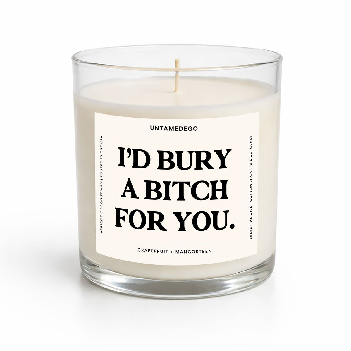A glass jar candle with white wax and a humorous black text label reading 'I'D BURY A BITCH FOR YOU.' on a clean white background.