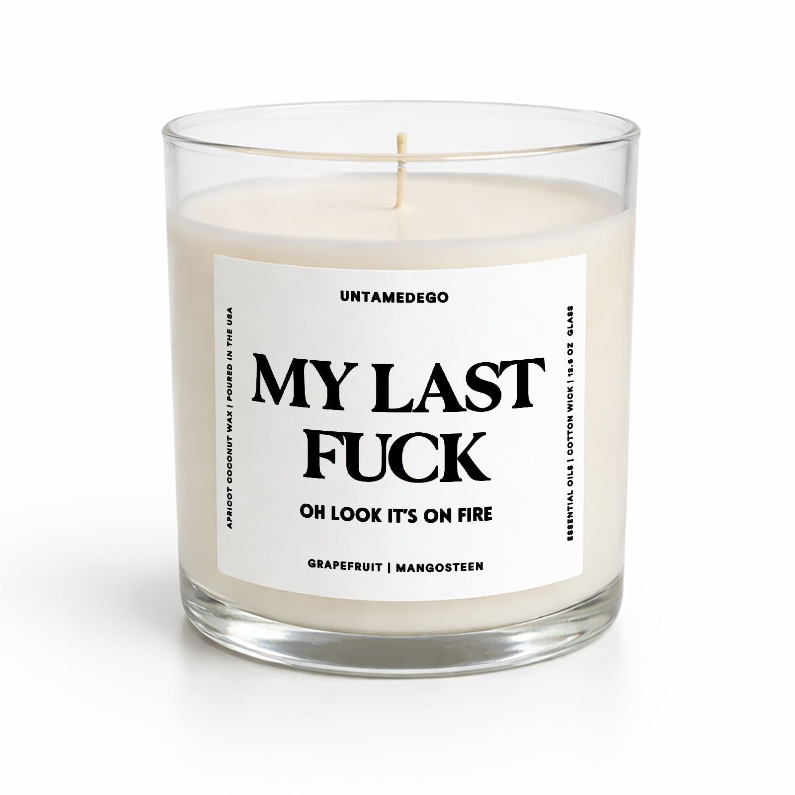 Candle in a glass jar with a label on a white background
