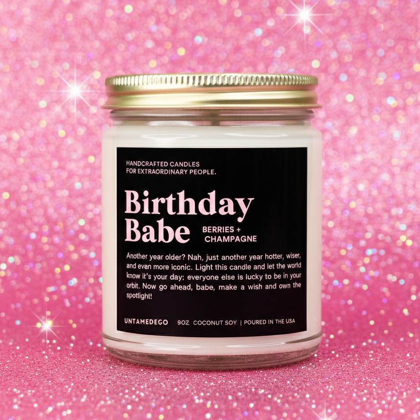 Candle labeled 'Birthday Babe' on a pink glittery background