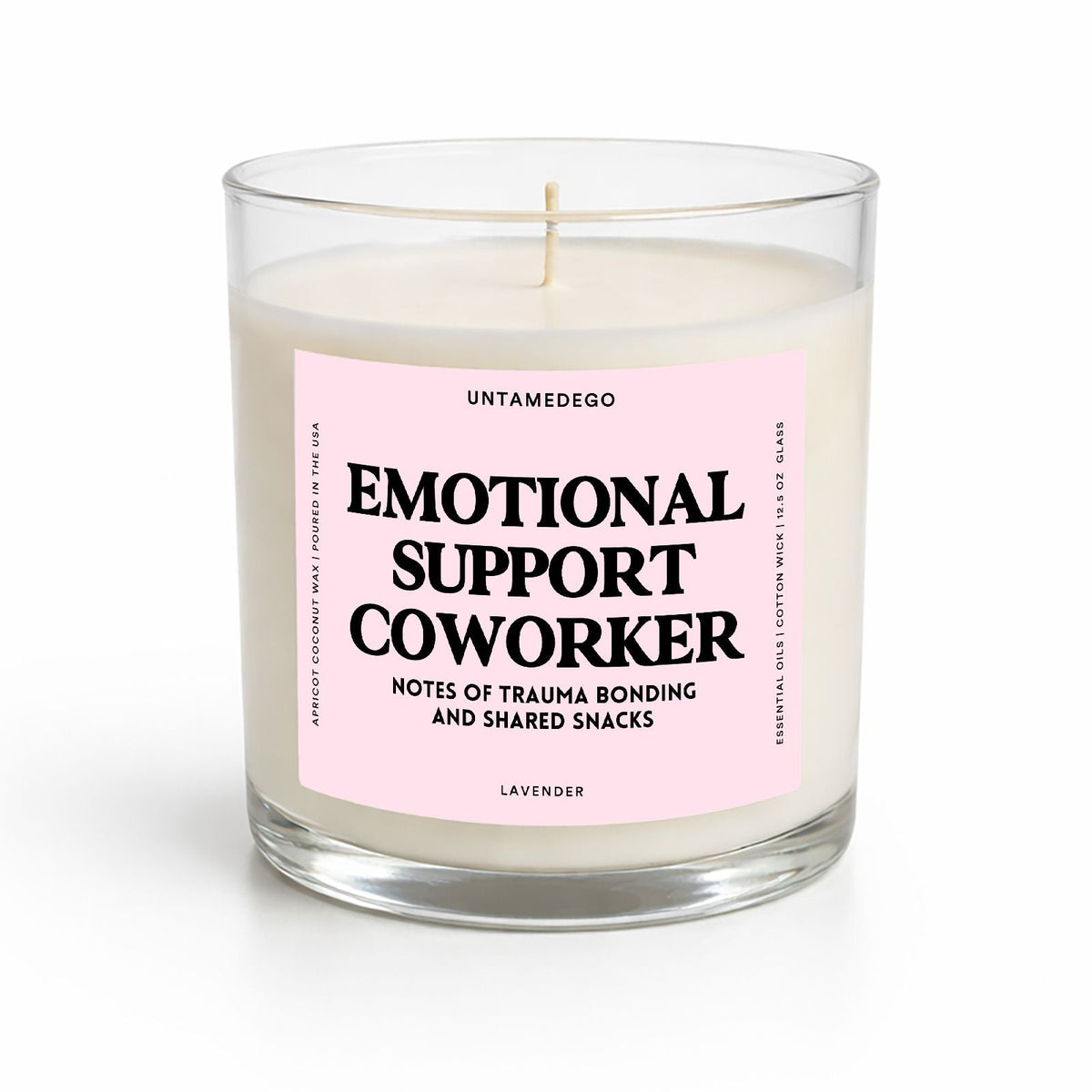 A clear glass jar candle with cream-colored wax and a light pink label that reads 'EMOTIONAL SUPPORT COWORKER' in bold black text. The candle is photographed on a clean white background with a soft shadow underneath.