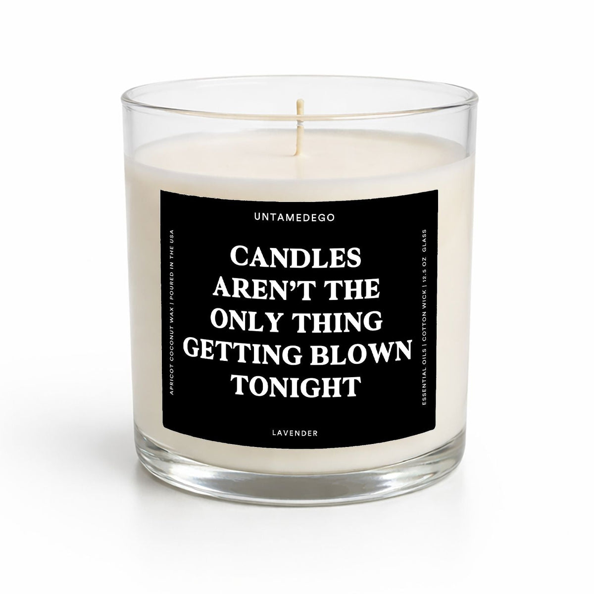 A clear glass jar candle with off-white wax and a black square label featuring white text that reads, 'CANDLES AREN'T THE ONLY THING GETTING BLOWN TONIGHT' with 'UNTAMEDOO' at the top and 'LAVENDER' at the bottom.