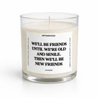 A lit scented candle in a clear glass jar with a white label that reads 'UNTAMEDEGO WE'LL BE FRIENDS UNTIL WE'RE OLD AND SENILE. THEN WE'LL BE NEW FRIENDS' and 'LAVENDER' at the bottom.