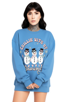 Person wearing a blue sweatshirt with snowmen graphics and text on a white background