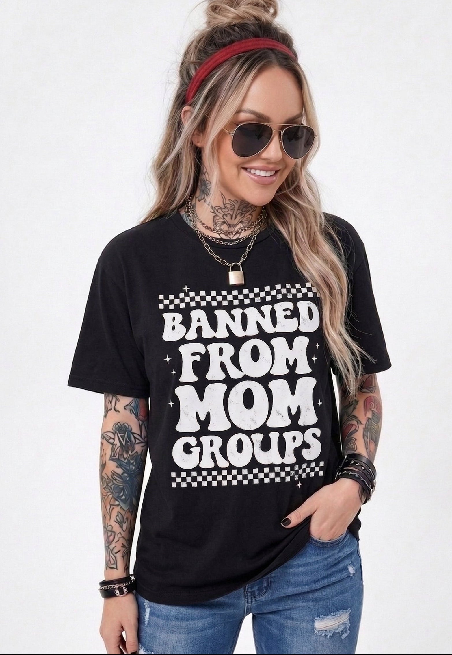 Woman wearing a black t-shirt with 'Banned from Mom Groups' text on a white background