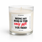 A single-wick candle in a clear glass jar with cream-colored wax and a white label featuring the text 'BEING MY BOSS IS THE only gift YOU NEED' in black and red lettering. The brand name 'UNTAMEDEGO' is visible at the top of the label.