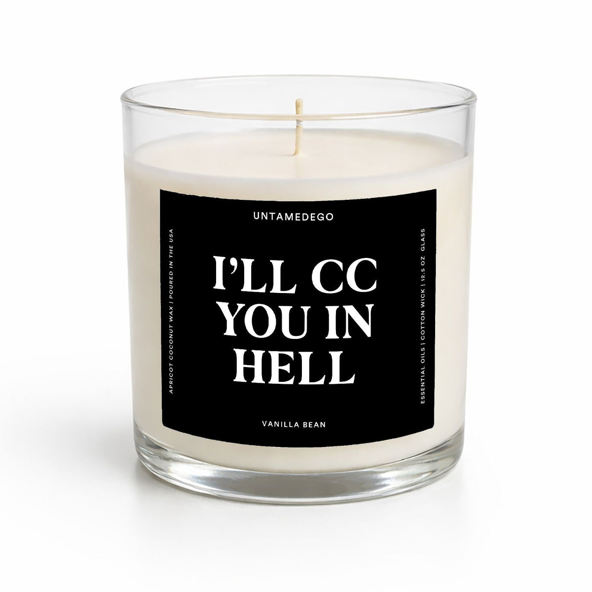 A clear glass jar candle with cream-colored wax and a black label featuring bold white text that reads 'I'LL CC YOU IN HELL' with the brand name 'UNTAMEDEGO' above, on a clean white background.