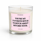 A clear glass jar candle with white wax and a pink front label featuring bold black text that reads, 'YOU'RE MY FAVORITE BITCH TO BITCH ABOUT BITCHES WITH.' The label also shows the brand name UNTAMEDEGO and the scent name VANILLA BEAN.