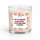 A single-wick candle in a clear glass jar with white wax and a pink label featuring cartoon cowboys and the text 'MY FAVORITE coworkER GAVE ME THIS CANDLE' on a white background.