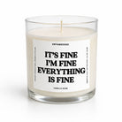 A clear glass jar candle with white wax and a white label that reads 'IT'S FINE I'M FINE EVERYTHING IS FINE' in bold black text. The brand name 'UNTAMEDEGO' is visible at the top of the label, with 'VANILLA SEAN' at the bottom.