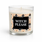A clear glass jar candle with white wax and a printed label reading 'WITCH PLEASE' on a peach background with cartoon cats, witches, and small purple butterflies. The candle is photographed on a clean white background.