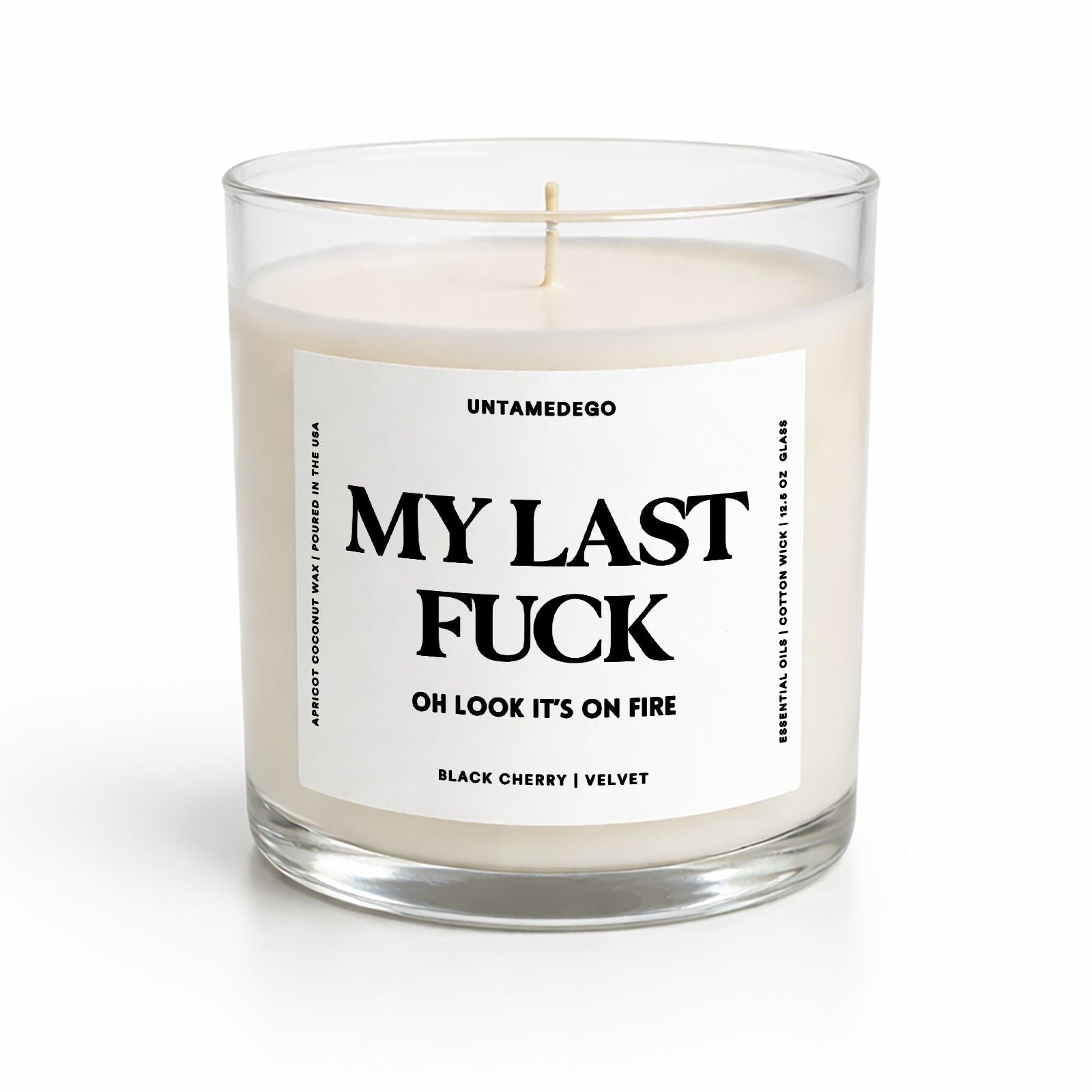 Candle in a glass jar with a label on a white background