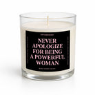 A clear glass jar candle with white wax and a black label featuring pink text that reads 'NEVER APOLOGIZE FOR BEING A POWERFUL WOMAN' by Untamedogo.