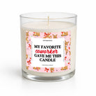A clear glass jar candle with white wax and a single wick, featuring a pink holiday-themed label with cartoon reindeer and the text 'MY FAVORITE coworker GAVE ME THIS CANDLE' on a white background.