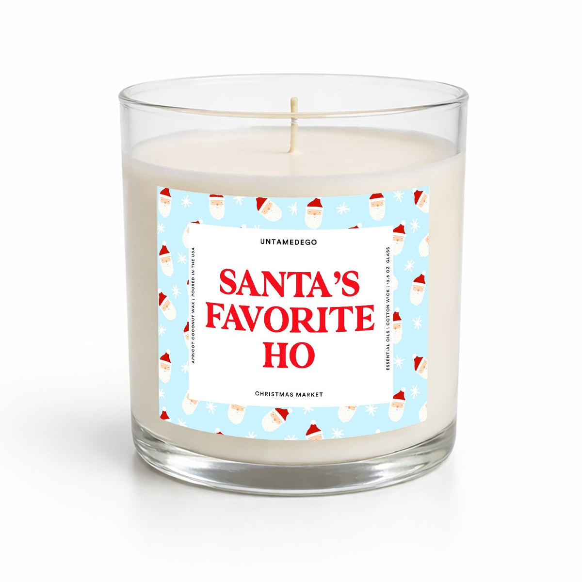 A clear glass jar candle with white wax and a festive label that reads 'SANTA'S FAVORITE HO' in red text on a light blue background with Santa illustrations, photographed on a clean white background.