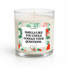 A clear glass jar candle with white wax and a wooden wick, featuring a festive Christmas-themed label with the text 'SMELLS LIKE YOU COULD GOOGLE YOUR QUESTIONS.' by Untamedeo.