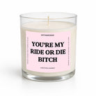 A single-wick soy candle in a clear glass jar with a light pink label that reads 'YOU'RE MY RIDE OR DIE BITCH' in bold black text. The brand name 'UNTAMEDEGO' is visible at the top of the label, with 'CHRISTMAS MARKET' at the bottom.