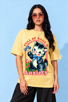A woman modeling a yellow graphic t-shirt with a cartoon kitten and the words 'FULL OF RAGE & Anxiety' against a light blue background.