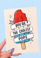 Card with a popsicle illustration and text 'You're the coolest pops' on a blue background
