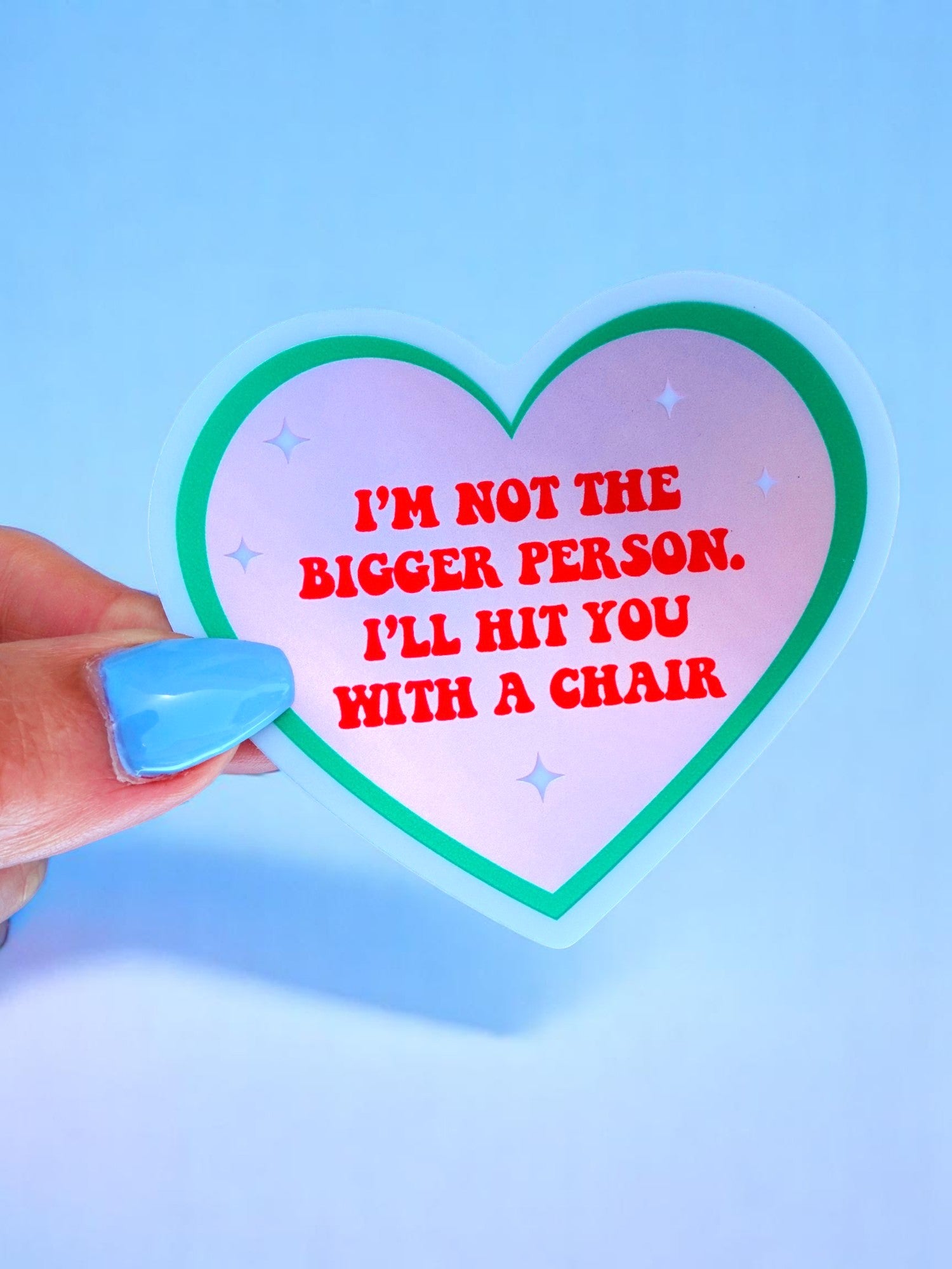 Funny heart-shaped vinyl sticker with pink and green border. Text reads “I’m Not the Bigger Person. I’ll Hit You with a Chair.”