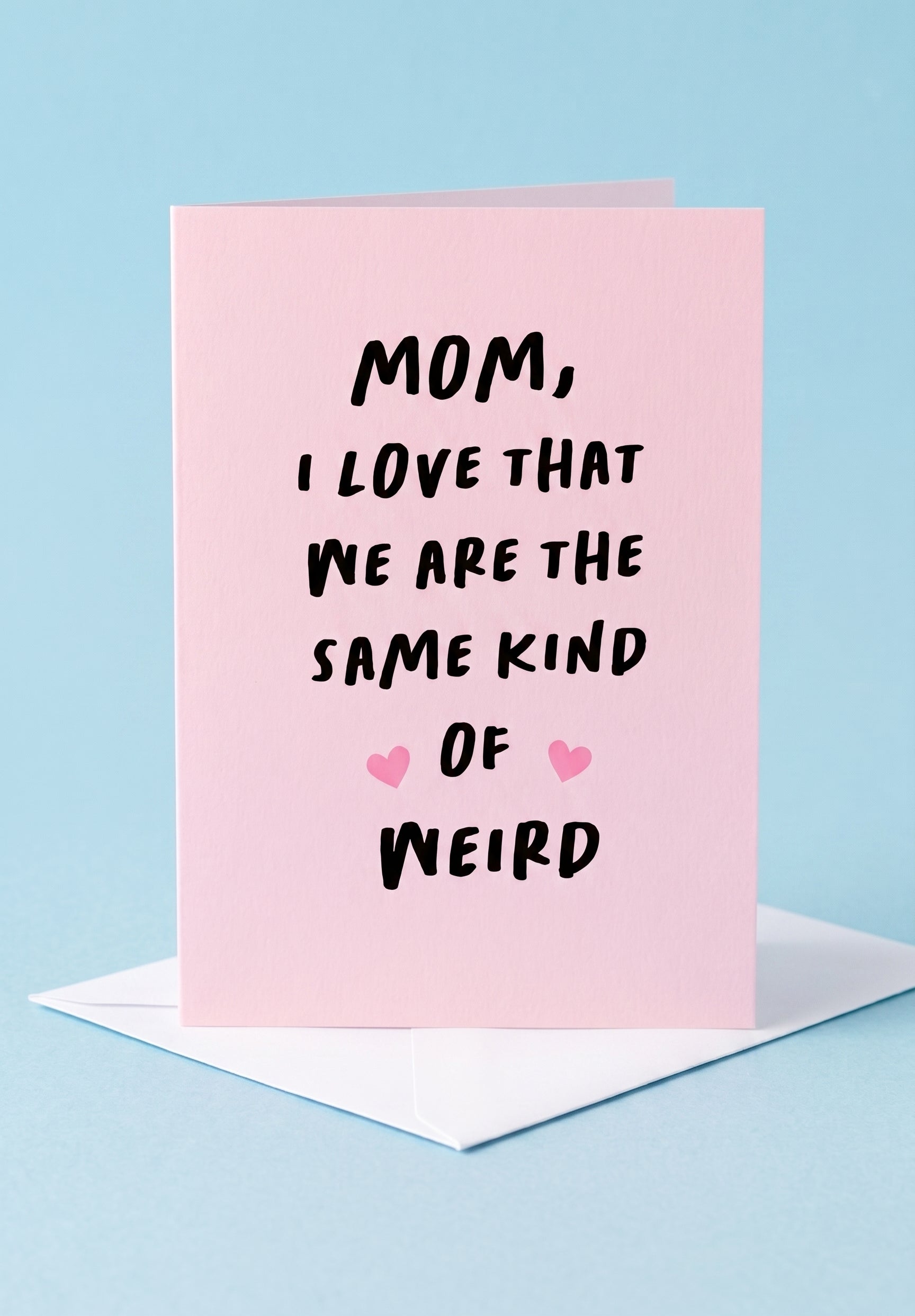 Greeting card with text 'Mom, I love that we are the same kind of weird' on a pink background