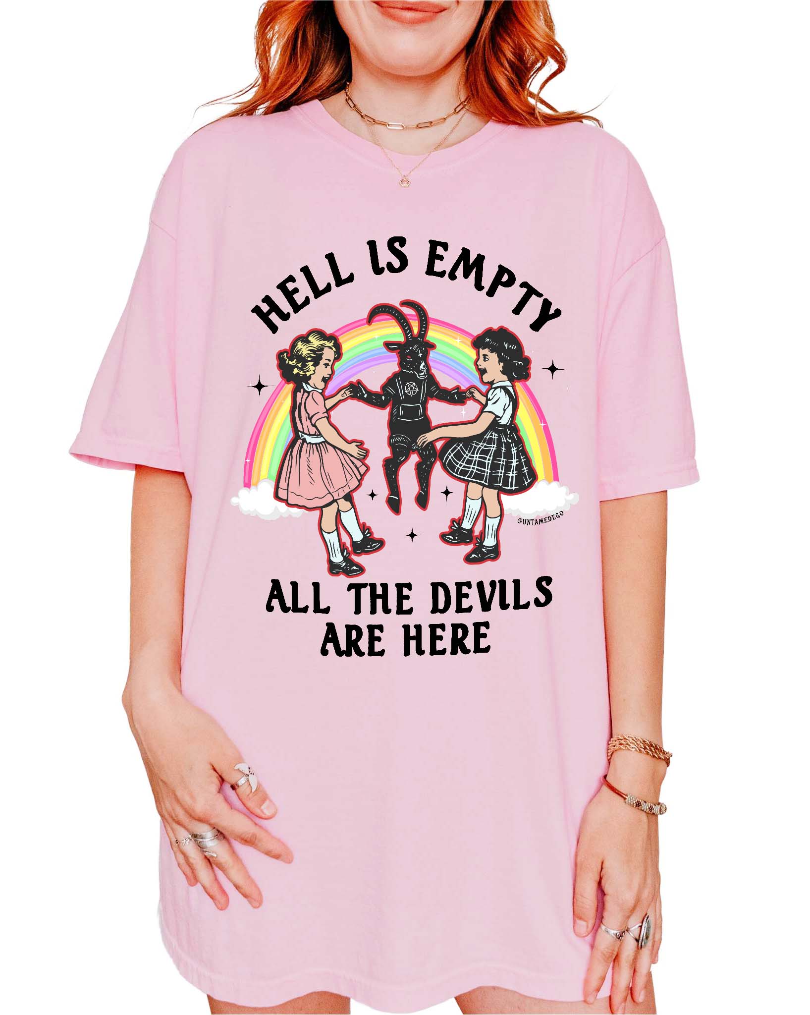 Person wearing a pink t-shirt with a graphic design and text.