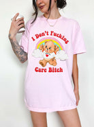 Funny graphic t-shirt with cute bear and rainbow design and bold text expressing not caring attitude