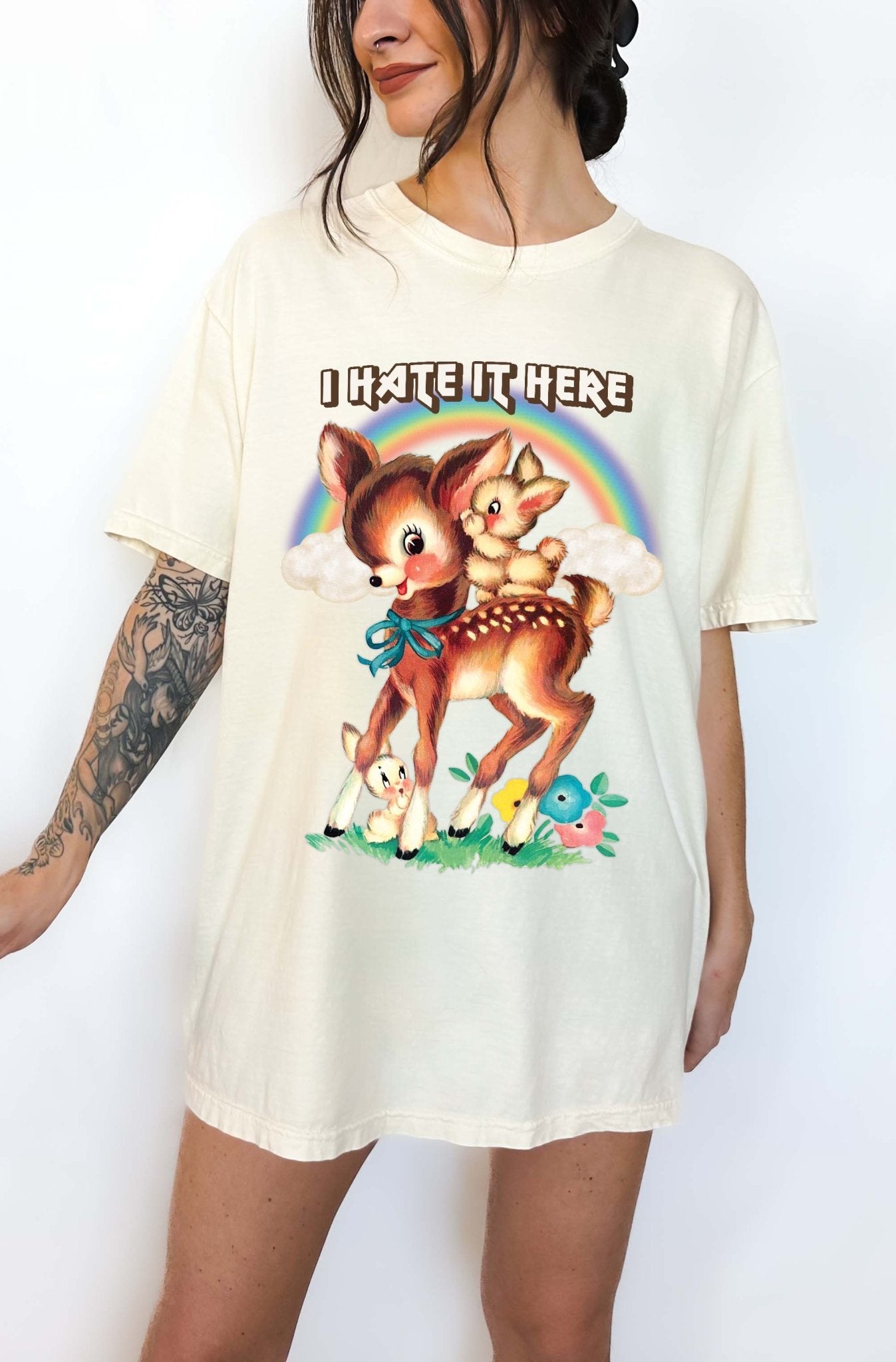 Funny graphic t-shirt with cute deer illustration and text saying I hate it here