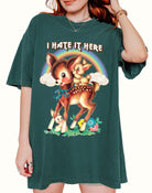 Funny graphic t-shirt with cute deer illustration and text saying I hate it here