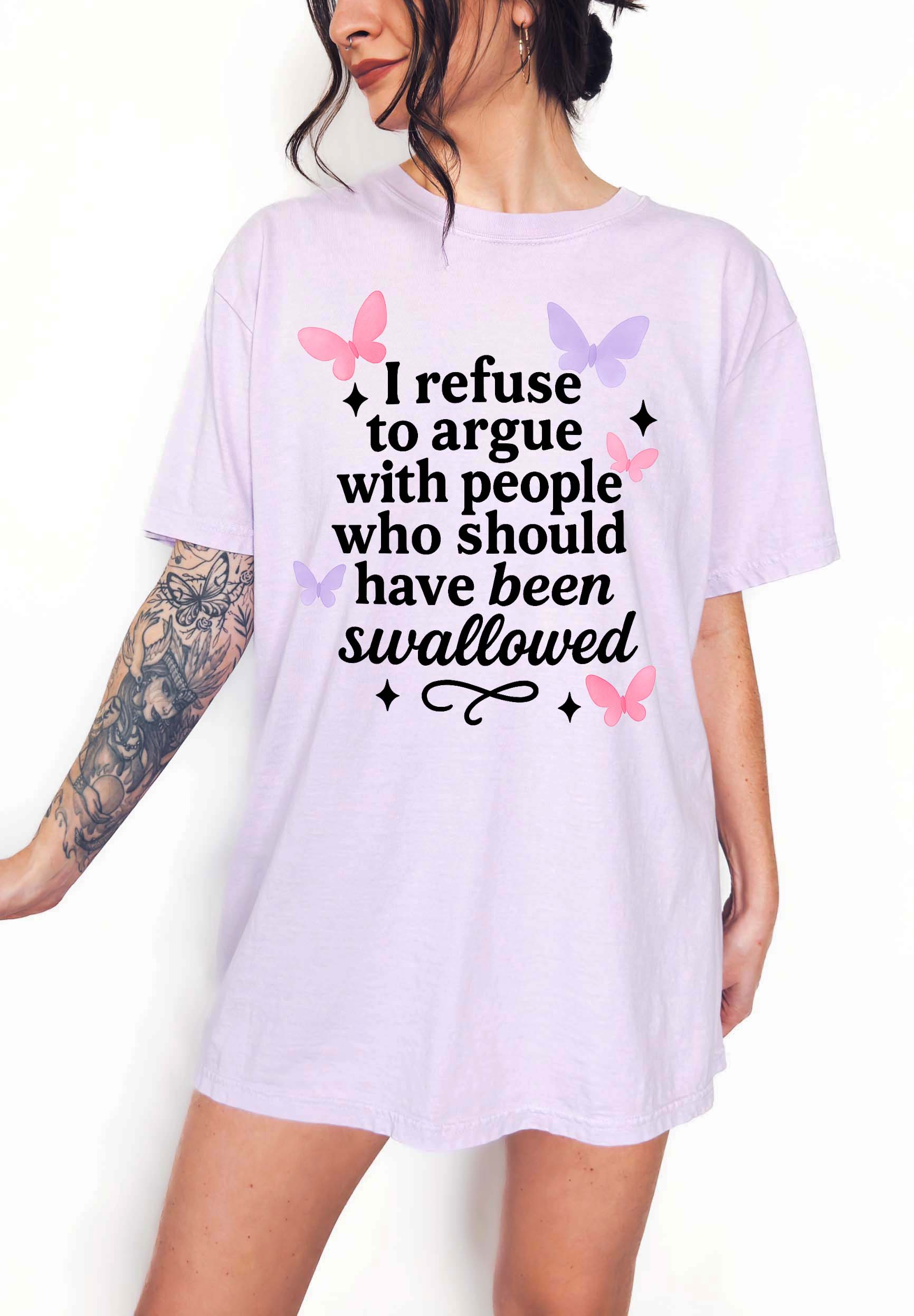 Person wearing a white t-shirt with a humorous text design on a plain background