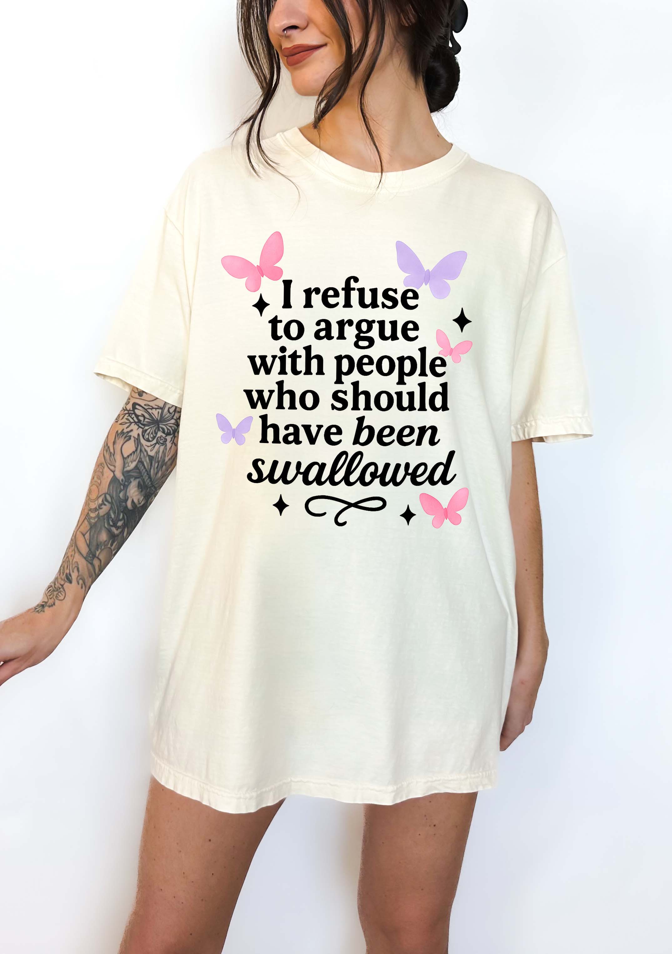 Person wearing a white t-shirt with a humorous text design on a plain background