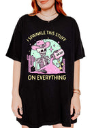 Funny graphic t-shirt with skeleton sprinkling sarcasm and text saying I sprinkle this stuff on everything