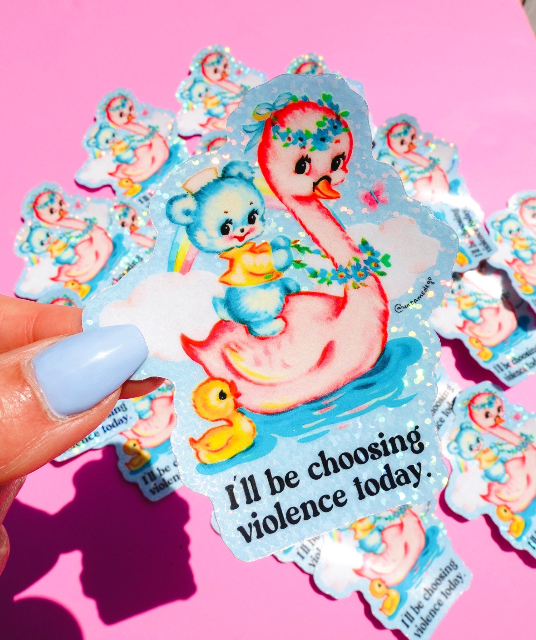 ie-cut holographic vinyl sticker featuring a retro-kawaii baby bear in a bathtub holding a rainbow, with a rubber duck, on a pastel blue background. Bold black text reads: I'll be choosing violence today.