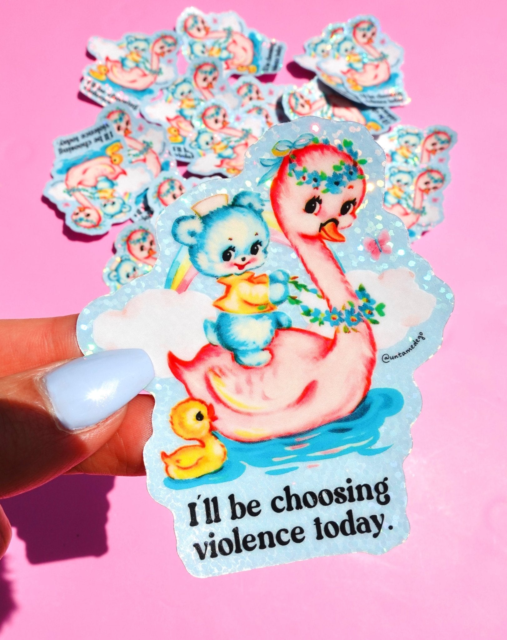 Die-cut holographic vinyl sticker featuring a retro-kawaii baby bear in a bathtub holding a rainbow, with a rubber duck, on a pastel blue background. Bold black text reads: I'll be choosing violence today.