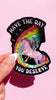 Funny holographic sticker with skeleton riding a unicorn and text “have the day you deserve” cute dark humor vinyl sticker