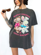 Protest graphic t-shirt with vintage teddy bear and bunny design and text saying respect existence or expect resistance