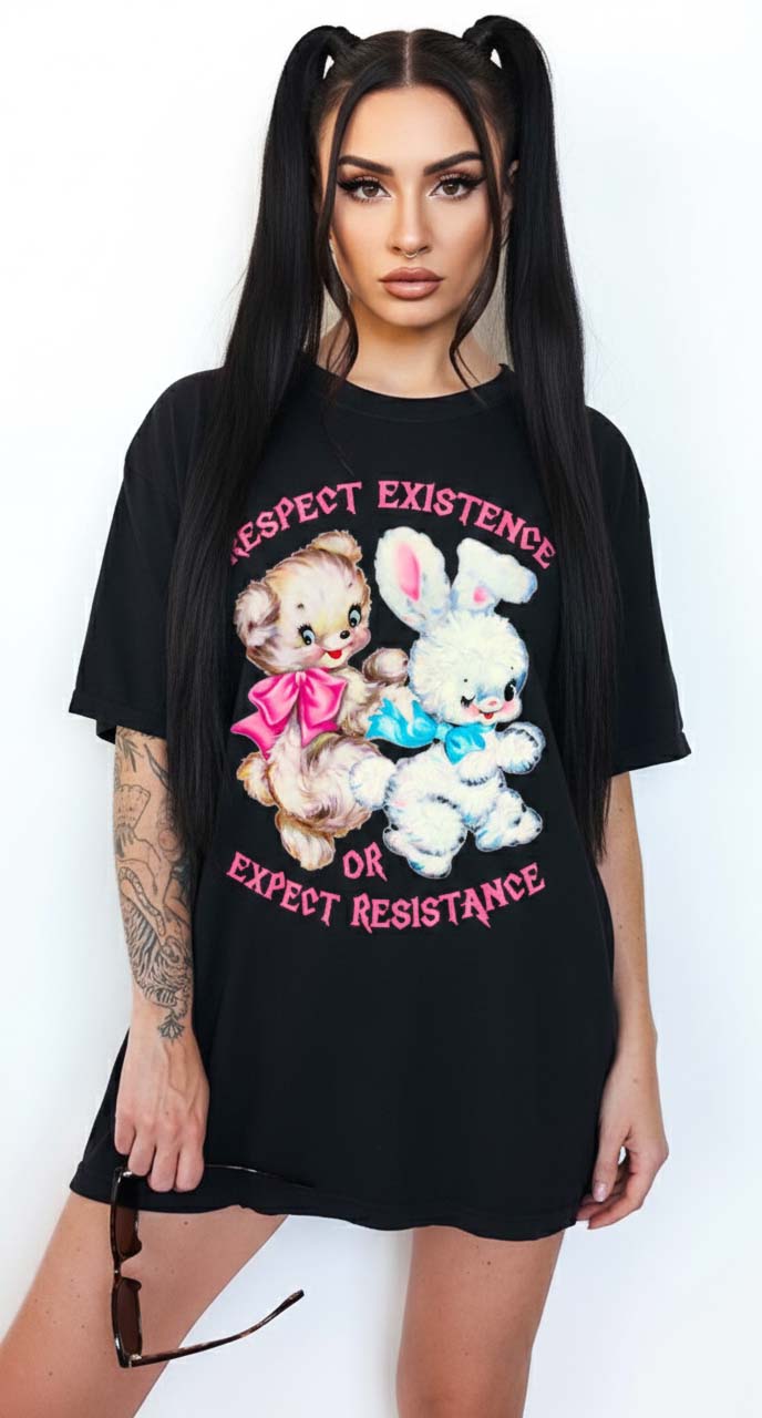 Person wearing a black graphic t-shirt featuring two illustrated characters and the text Respect Existence Or Expect Resistance, photographed against a light background