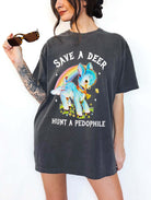 Vintage style deer graphic t-shirt with rainbow design and bold statement text, worn oversized on a model