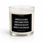 A glass jar candle with cream-colored wax and a black label featuring white text that reads, 'SMELLS LIKE THIS MEETING SHOULD HAVE BEEN AN EMAIL.' The brand name 'UNTAMEDEGO' is visible at the top of the label.