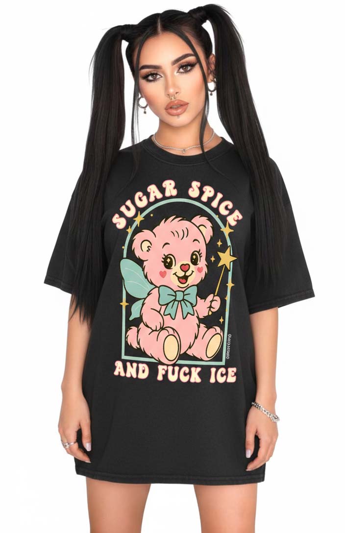 Person wearing a black graphic t-shirt featuring a pastel illustrated bear holding a wand and text that reads Sugar Spice and F star ICE, photographed against a white background