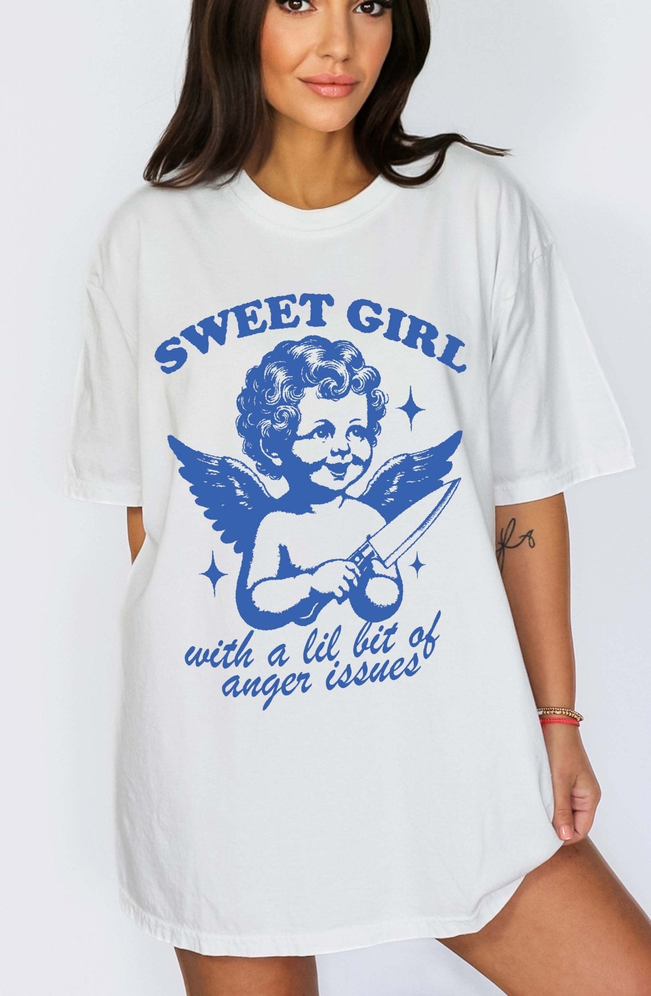 Graphic t-shirt with vintage angel illustration holding knife and text saying sweet girl with anger issues