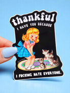 Funny vinyl sticker with retro-style girl and kittens on a rug. Text reads “Thankful I Have You Because I F*cking Hate Everyone.”