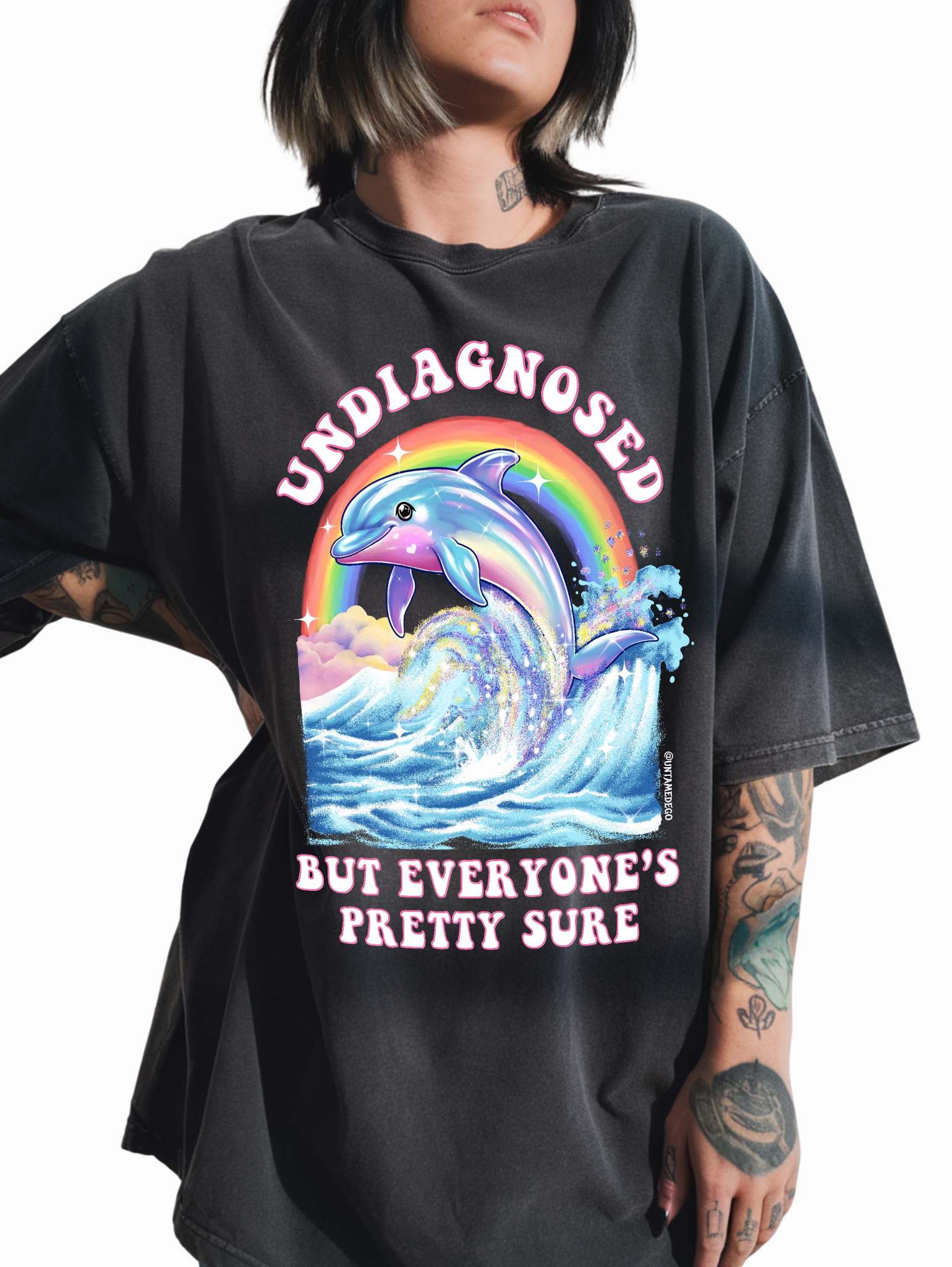 Funny graphic t-shirt with dolphin and rainbow design and text saying undiagnosed but everyone’s pretty sure