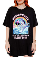 Funny graphic t-shirt with dolphin and rainbow design and text saying undiagnosed but everyone’s pretty sure